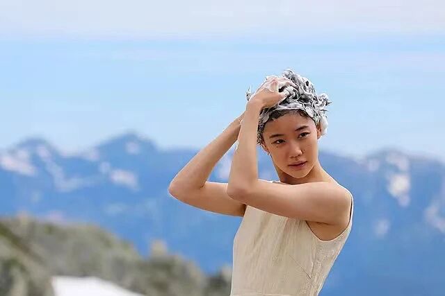 背负春天-女主角在户外洗头